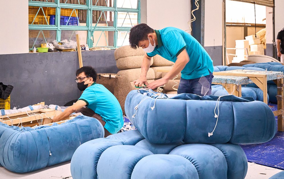 Sofa upholstery craftsmanship at Tan Hoang Gia factory in Vietnam