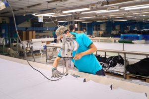 THG worker cutting sofa fabric