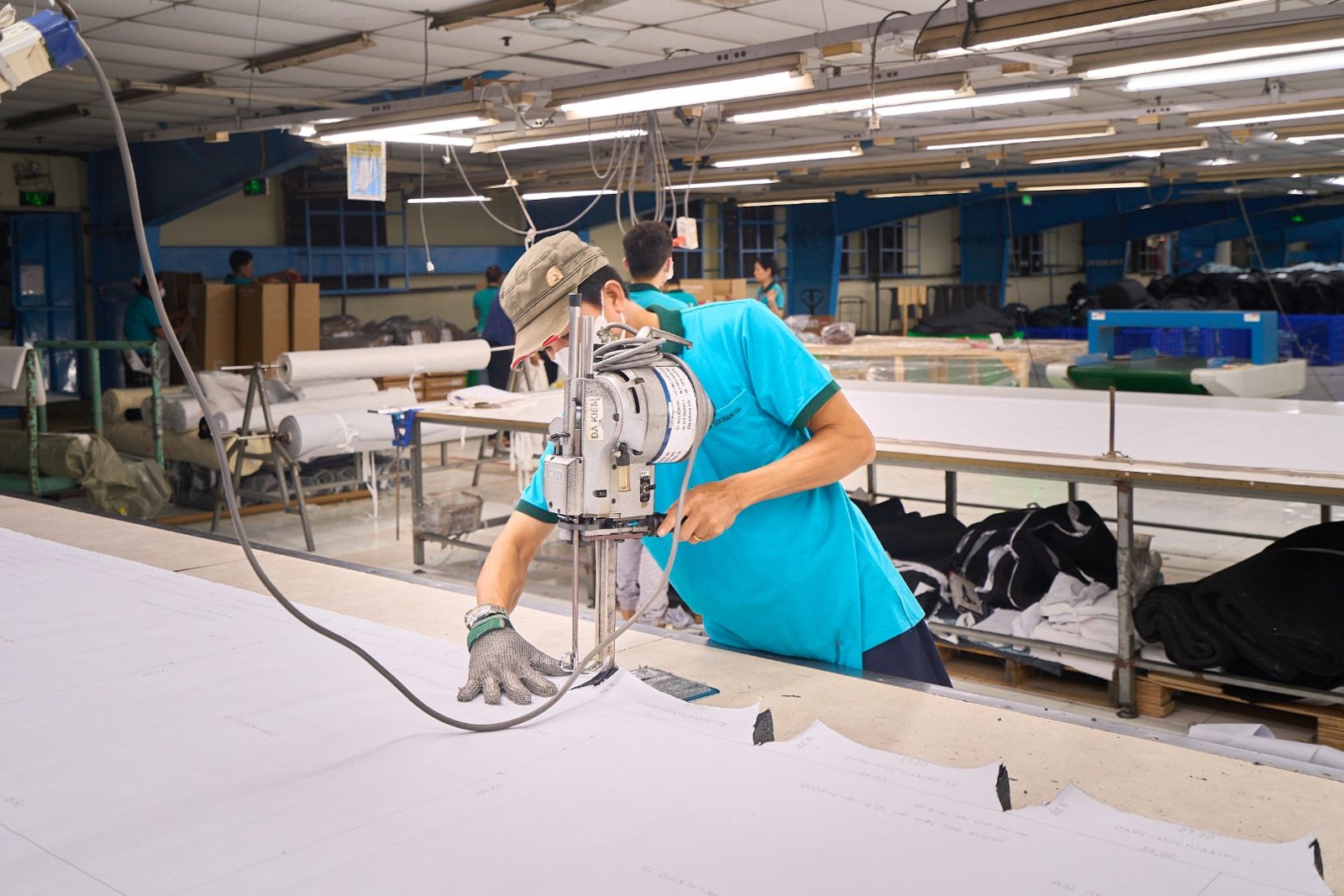 THG worker cutting sofa fabric